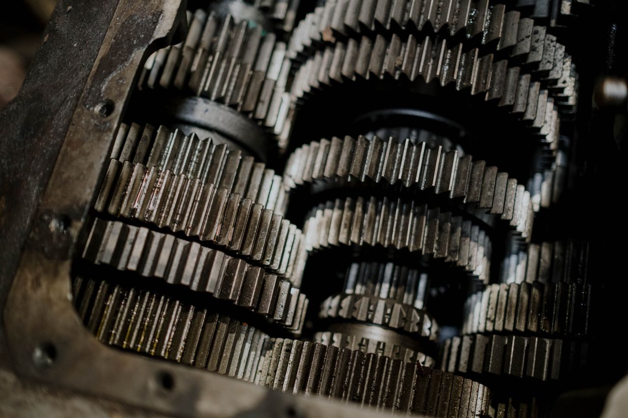 our-mission Detailed shot of mechanical gears showcasing intricate steel parts and engineering precision.
